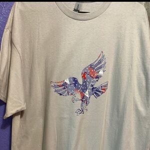 A beige shirt with an eagle￼